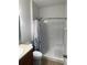 Full bathroom with shower featuring a white showerhead, toiletry niche, shower curtain, and grab bar at 518 Winthrop Dr, Spring Hill, FL 34609