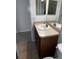 Bathroom featuring a single sink vanity with light wood cabinets and a mirror with silver fixtures at 518 Winthrop Dr, Spring Hill, FL 34609