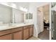 Spacious bathroom with double sinks, cabinets, and a view to the bedroom at 518 Winthrop Dr, Spring Hill, FL 34609