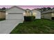 Charming single-story home featuring a two-car garage and well-maintained lawn at 518 Winthrop Dr, Spring Hill, FL 34609