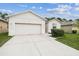 Well-maintained single-story home showcasing a two-car garage and neatly kept lawn at 518 Winthrop Dr, Spring Hill, FL 34609