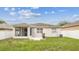 The rear exterior shows the backyard, patio, and screened-in porch at 518 Winthrop Dr, Spring Hill, FL 34609