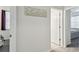 Bright hallway featuring neutral paint, wood-look flooring and decorative wall art to complement this lovely home at 518 Winthrop Dr, Spring Hill, FL 34609
