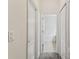 Hallway view leading to a bathroom with a tub and tiled floor at 518 Winthrop Dr, Spring Hill, FL 34609