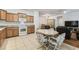 Open kitchen featuring wood cabinets, granite countertops, tile floors and stainless steel appliances at 518 Winthrop Dr, Spring Hill, FL 34609