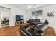 Cozy living room featuring hardwood floors, ample natural light, and comfortable furniture at 518 Winthrop Dr, Spring Hill, FL 34609