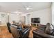 Bright and airy living area with hardwood floors, ample seating, and a TV entertainment center at 518 Winthrop Dr, Spring Hill, FL 34609