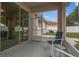 Screened patio featuring seating area with an outdoor view and access to the house through sliding glass doors at 518 Winthrop Dr, Spring Hill, FL 34609