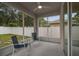Relaxing screened-in patio with ceiling fan and view of the fenced backyard at 518 Winthrop Dr, Spring Hill, FL 34609