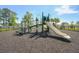 Community playground with slide and climbing structures surrounded by a secure black fence at 518 Winthrop Dr, Spring Hill, FL 34609