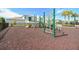 Community playground with slides, monkey bars and climbing structures set on a red safety surface at 518 Winthrop Dr, Spring Hill, FL 34609