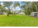 Expansive backyard with mature trees, offering ample space and privacy at 523 2Nd Sw Ave, Lutz, FL 33548