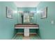 Bathroom featuring a long vanity, large mirror, artwork, and tile flooring at 523 2Nd Sw Ave, Lutz, FL 33548