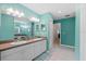 Bathroom featuring double sinks, vanity, and blue-green walls at 523 2Nd Sw Ave, Lutz, FL 33548