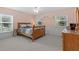 Comfortable bedroom featuring two windows providing natural light, carpeted floors, and wood furnishings at 523 2Nd Sw Ave, Lutz, FL 33548