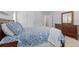 Bedroom featuring natural light, soft carpet, warm wood furnishings, and calming blue decor at 523 2Nd Sw Ave, Lutz, FL 33548