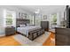 Spacious bedroom with large windows, ceiling fan, wooden floors, and neutral color palette at 523 2Nd Sw Ave, Lutz, FL 33548
