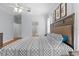 Beautiful bedroom features a large patterned bed, ceiling fan, and wooden floors at 523 2Nd Sw Ave, Lutz, FL 33548