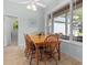 Bright dining room with large window, tile flooring, and a wooden table with seating at 523 2Nd Sw Ave, Lutz, FL 33548
