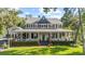 Beautifully landscaped two-story house with a large, wraparound porch at 523 2Nd Sw Ave, Lutz, FL 33548