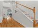 Bright foyer featuring hardwood floors and an elegant staircase at 523 2Nd Sw Ave, Lutz, FL 33548