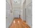 Bright foyer with high ceilings, hardwood floors, and a decorative chandelier creates a welcoming entrance at 523 2Nd Sw Ave, Lutz, FL 33548