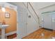 Inviting foyer with hardwood floors and staircase next to a convenient powder room with stylish sink at 523 2Nd Sw Ave, Lutz, FL 33548