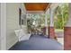 Relaxing front porch with swing and outdoor seating, perfect for enjoying the serene surroundings at 523 2Nd Sw Ave, Lutz, FL 33548
