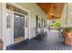 Charming front porch featuring rocking chairs and a welcoming entrance at 523 2Nd Sw Ave, Lutz, FL 33548