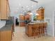 Open kitchen featuring an island with bar seating, ample storage, and modern appliances at 523 2Nd Sw Ave, Lutz, FL 33548