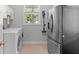 Laundry room with tile flooring, stainless steel refrigerator, washer, and dryer at 523 2Nd Sw Ave, Lutz, FL 33548