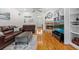 Living room features hardwood floors, fireplace, built-in shelving, and comfortable seating at 523 2Nd Sw Ave, Lutz, FL 33548