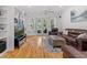 Bright living room with hardwood floors, built-in shelving, and access to the backyard at 523 2Nd Sw Ave, Lutz, FL 33548