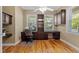 Home office with hardwood floors, built-in shelving, and natural light from the windows at 523 2Nd Sw Ave, Lutz, FL 33548