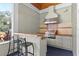Well-equipped outdoor kitchen with a built-in grill and bar seating at 523 2Nd Sw Ave, Lutz, FL 33548
