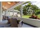Outdoor view from a sunroom featuring wicker furniture, natural light, and green grass at 523 2Nd Sw Ave, Lutz, FL 33548