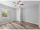 Neutral bedroom features new floors, ceiling fan, and a bright window at 5514 7Th N Ave, St Petersburg, FL 33710