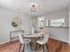 The dining room offers a round table and decor with view of kitchen at 5514 7Th N Ave, St Petersburg, FL 33710