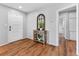 Welcoming foyer with stylish wood flooring, console table, and neutral wall color at 5514 7Th N Ave, St Petersburg, FL 33710