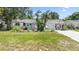 Charming single-story home featuring a well-manicured lawn and vibrant landscaping at 5514 7Th N Ave, St Petersburg, FL 33710