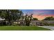 Charming one-story home with a well-manicured lawn during an evening sunset at 5514 7Th N Ave, St Petersburg, FL 33710