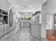 Modern kitchen with white cabinets, stainless steel appliances, and unique patterned flooring at 5514 7Th N Ave, St Petersburg, FL 33710