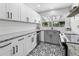 Stylish kitchen featuring white cabinets, granite countertops, and attractive black and white flooring at 5514 7Th N Ave, St Petersburg, FL 33710