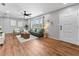 Inviting living room featuring wood flooring, a comfortable green sofa, and natural light at 5514 7Th N Ave, St Petersburg, FL 33710