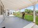 Covered patio with string lights overlooking a spacious backyard with a shed at 5514 7Th N Ave, St Petersburg, FL 33710