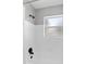 Walk-in shower features black shower head and new white tiles at 5514 7Th N Ave, St Petersburg, FL 33710
