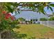 Expansive backyard with well-maintained lawn, mature trees, and a white fence enhancing the property's appeal at 5710 Tortoise Pl, Apollo Beach, FL 33572