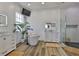 Modern bathroom has white shiplap walls, dual vanities, a soaking tub, and glass enclosed shower at 5710 Tortoise Pl, Apollo Beach, FL 33572