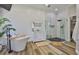 Modern bathroom features white shiplap walls, dual vanities, a soaking tub, and glass enclosed shower at 5710 Tortoise Pl, Apollo Beach, FL 33572