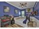 Vibrant blue bedroom featuring a single bed, wood flooring, and natural light at 5710 Tortoise Pl, Apollo Beach, FL 33572